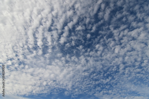 Fototapeta Naklejka Na Ścianę i Meble -  Evening white clouds on blue sky before sunset