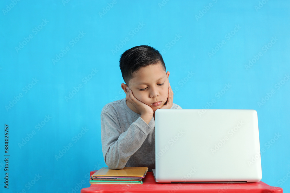 Tired little boy feel bored and sleepy while studying Tired little boy feel bored and sleepy while studying