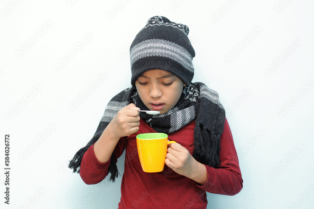 Children drink medicine, suffer from flu, fever headache and cough stock photo, isolated on white background Children drink medicine, suffer from flu, fever headache and cough stock photo, isolated on white background