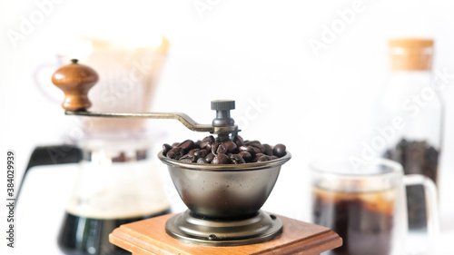 Coffee set  fresh roasted coffee beans in the mill manual coffee grinder and glass bottle black coffee paper drip isolated white background