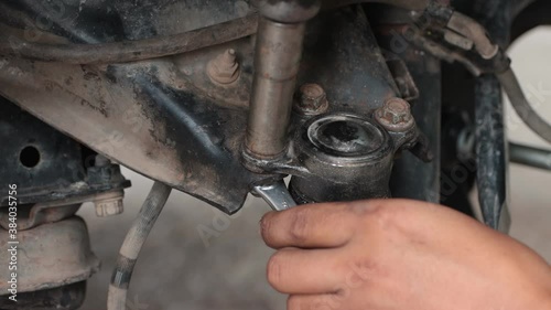 Hand of Car Mechanic Tight Bolt of Upper Arm Ball Joint or Car Part by Wind Block Tool