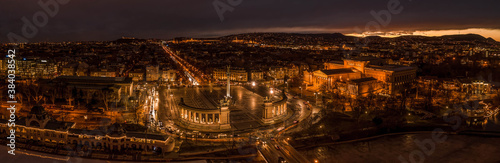 Aerial panoramic drone shot of Heroes Square in the night in Budapest winter with city lights