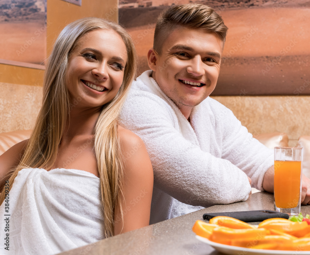 Nice young sexy couple shot at table in sauna Nice young sexy couple shot at table in sauna