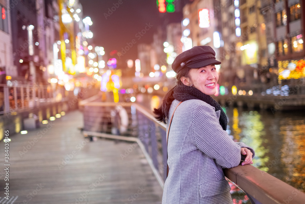 Φωτογραφία Beautiful smiling woman tourists traveling in walking at street shopping center Dotonbori in Osaka, Japan