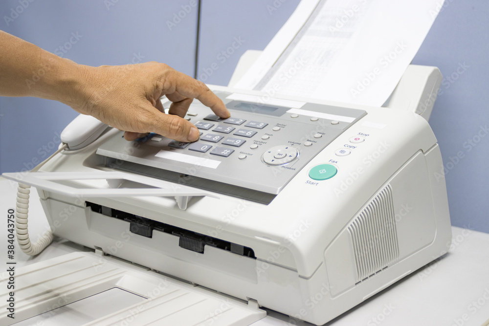 hand man are using a fax machine in the office, equipment for data transmission. hand man are using a fax machine in the office, equipment for data transmission.