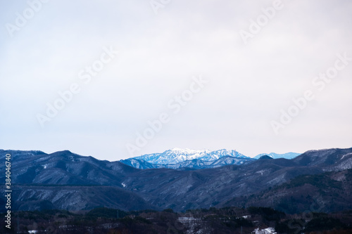 Landscape of big mountain range with snow on top in winter view from Kusatsu Onsen, Japan