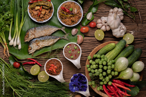 Shrimp paste  mackerel  fried on banana leaves  chili  tomato  garlic and lemon on wooden floor.