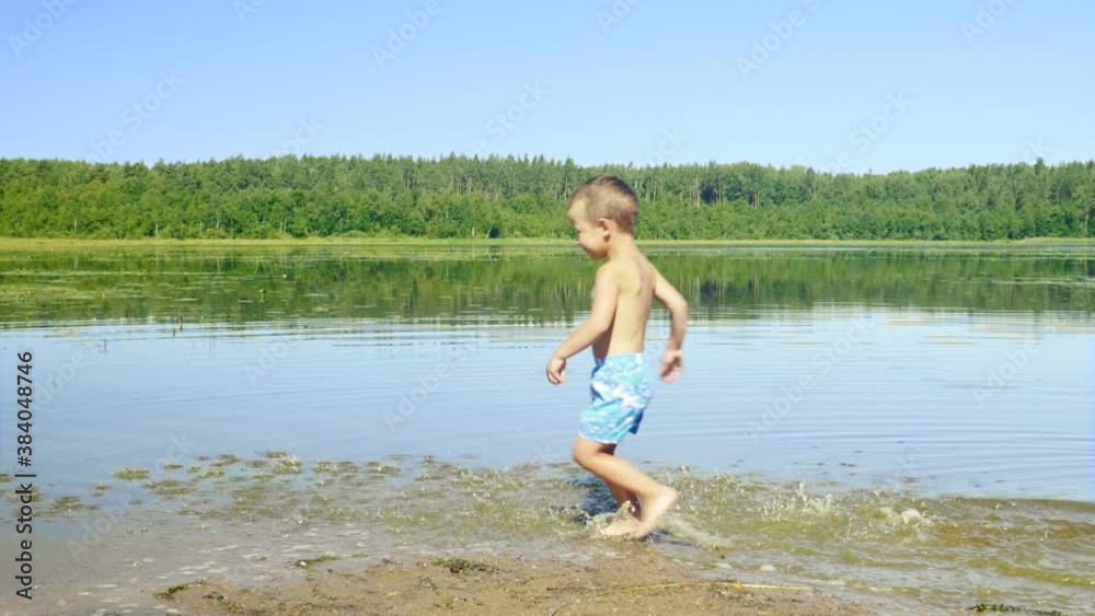 Slow motion shot of little boy running along the lake
Slow motion shot of little boy running along the lake