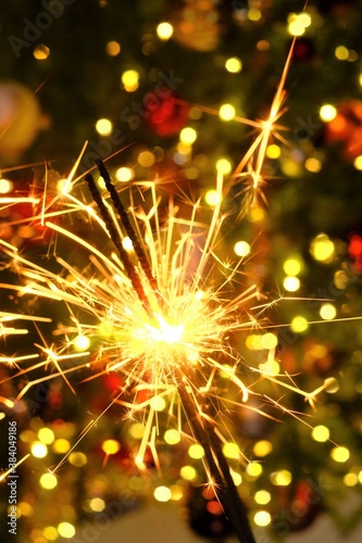 Bengal light.Sparkler sparks.Christmas and new year festive background. Bengal fire on a festive Christmas tree on background.Winter holidays beautiful background.