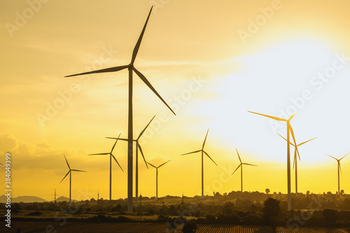 Wind turbines, Eco power and agricultural fields with cloudy day sunset landscapes on the mountain, Energy Production with clean and Renewable Energy. Protection of nature.
