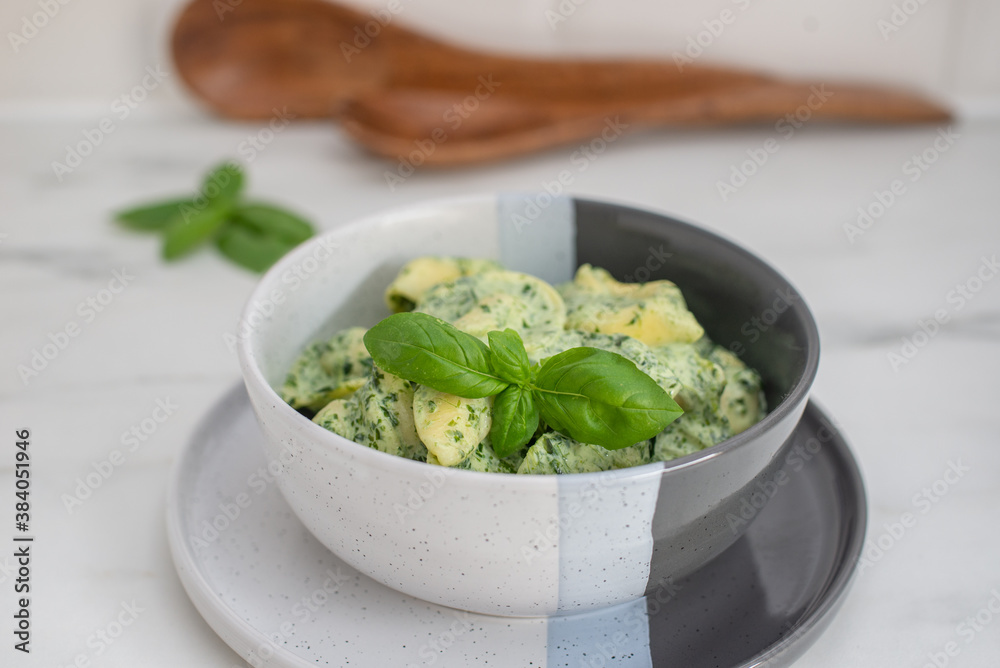 Italian Tortellini with spinach and basil on a table Italian Tortellini with spinach and basil on a table