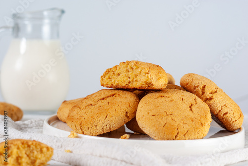 Homemade golden brown corn coockies on a white plate with selective focus, close up photo
