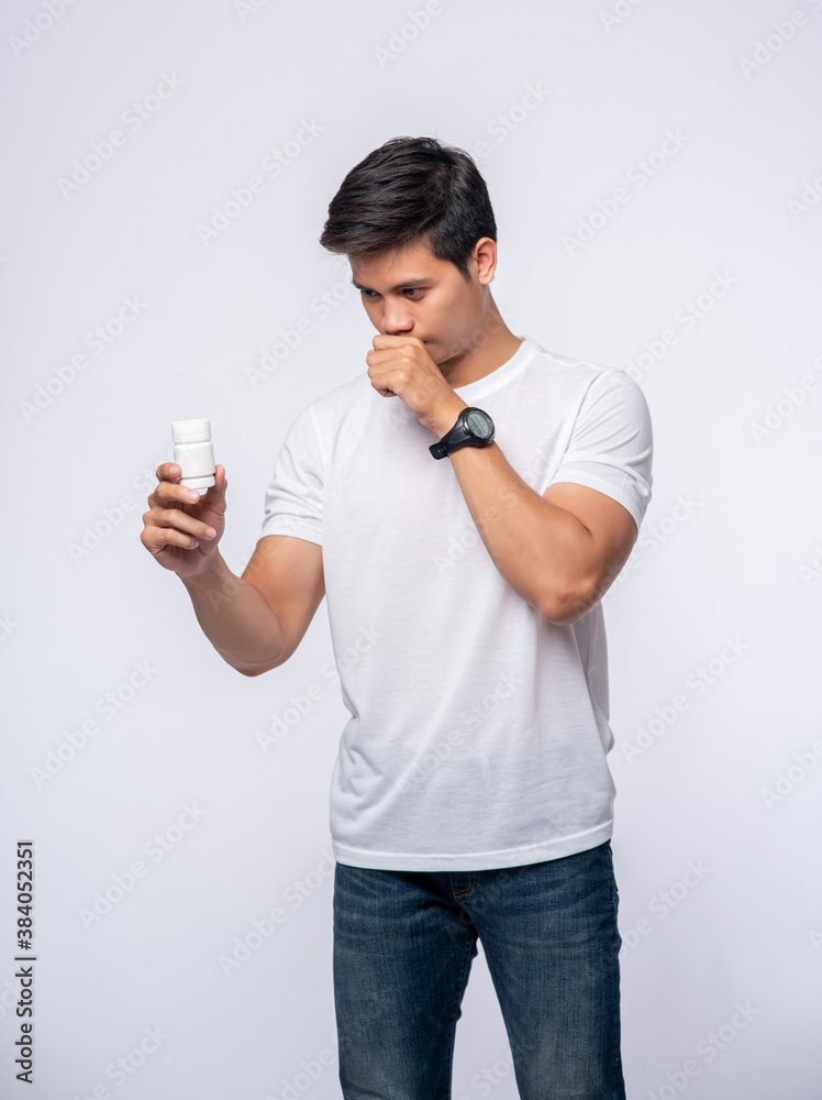 A man who is sick and carries a medicine bottle. A man who is sick and carries a medicine bottle.