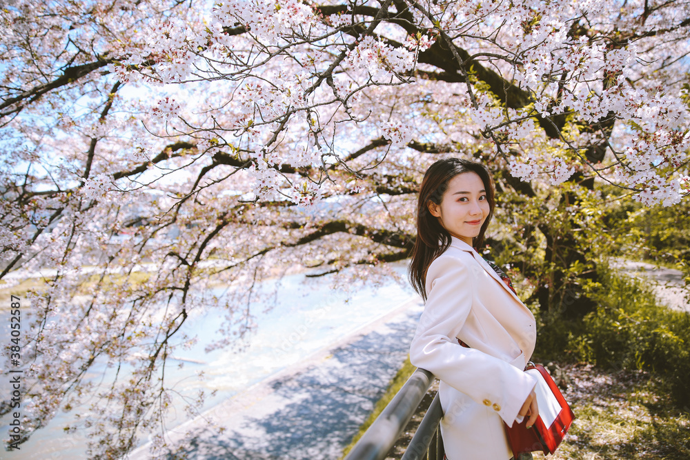 Girl and cherry blossoms in spring, Kyoto, Japan Girl and cherry blossoms in spring, Kyoto, Japan
