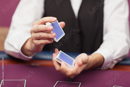 Dealer shuffling deck of cards in a casino