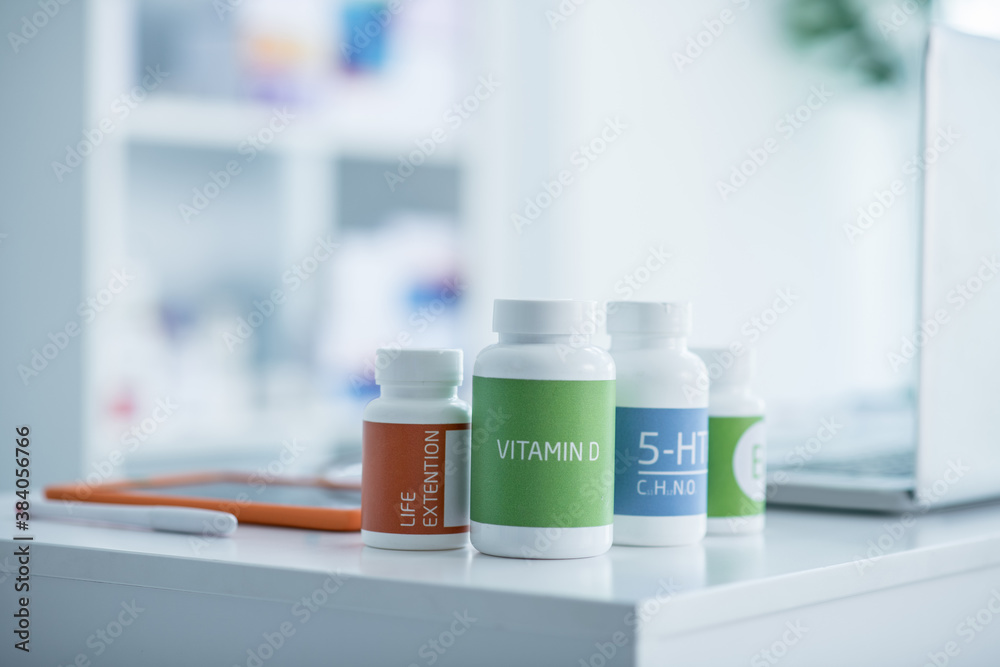 Bottles with different vitamines on the table Bottles with different vitamines on the table