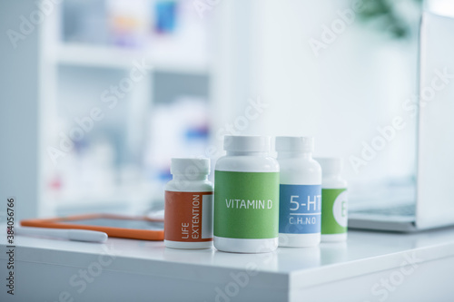 Bottles with different vitamines on the table photo