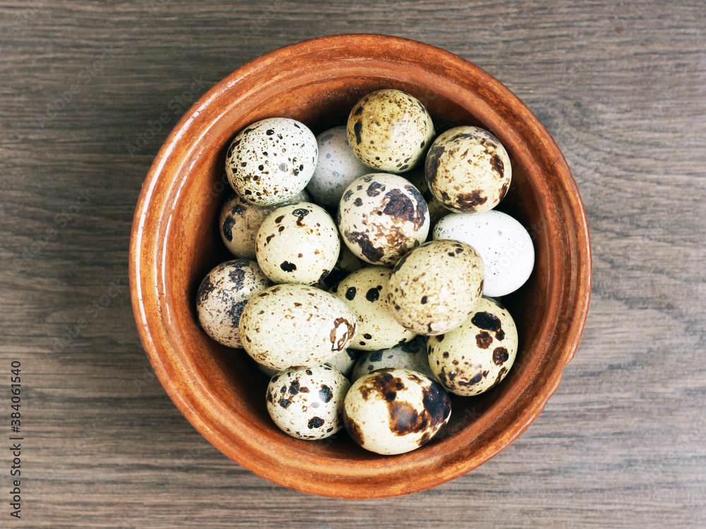 Group of quail eggs on a brown plate, top view Group of quail eggs on a brown plate, top view