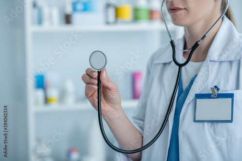 Doctor in a lab coat holding a stethoscope