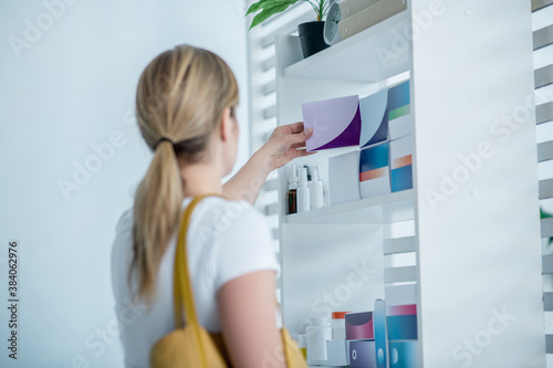 Woman choosing medicines in the drug store