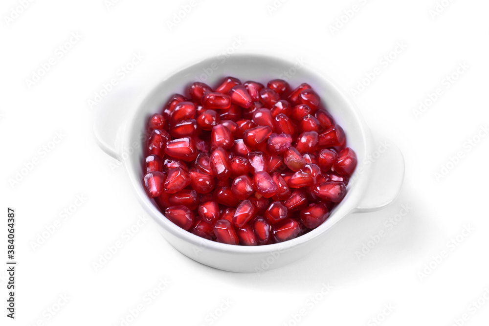 Pomegranate in white bowl on white background Pomegranate in white bowl on white background