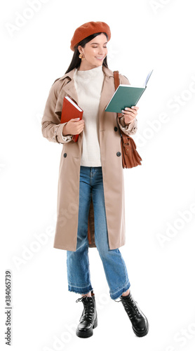 Beautiful young woman with books on white background