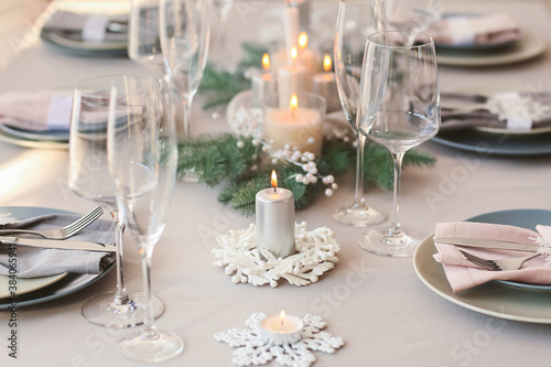 Beautiful table setting with candles for Christmas dinner