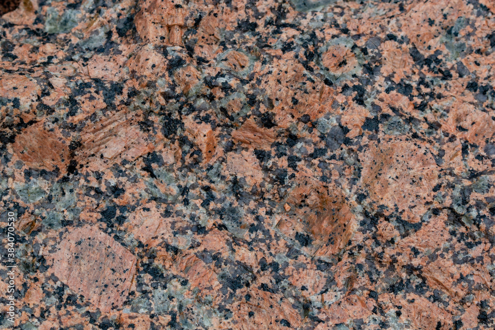 Texture of pink marine rapakivi granite with pronounced granules of feldspar, quartz and mica Texture of pink marine rapakivi granite with pronounced granules of feldspar, quartz and mica