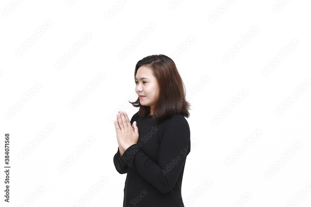 Portrait of young Asian woman wearing long sleeve shirt smiling and shows Asian greeting gesture isolated on white Portrait of young Asian woman wearing long sleeve shirt smiling and shows Asian greeting gesture isolated on white