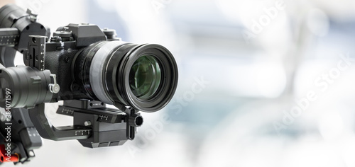 Gimbal video camera, Videographer using dslr camera anti shake tool for stabilizer record video. photo
