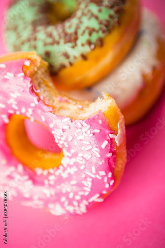 Studio shot of a colorful donuts on pink background. © Stockis