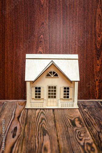 House symbol on a brown wooden background 