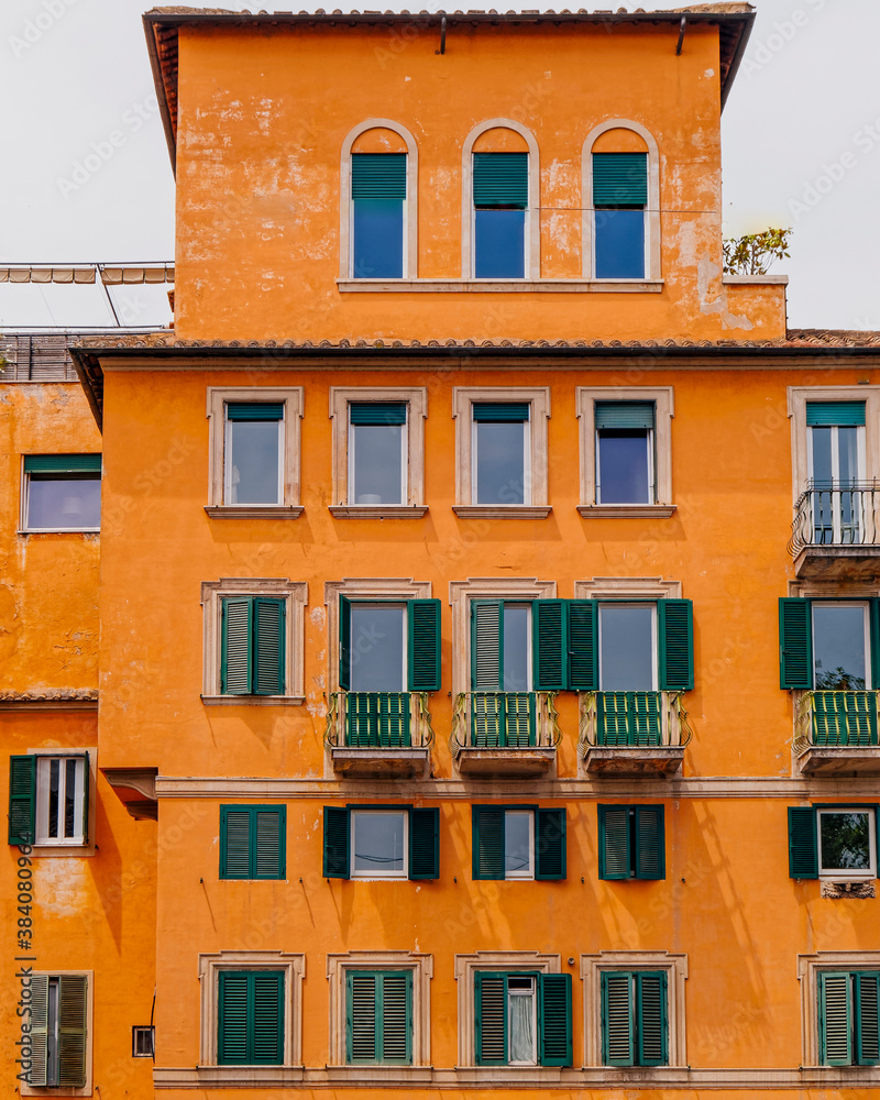 orange walls house front with green windows, Rome Italy orange walls house front with green windows, Rome Italy
