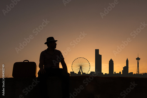 man next to seattle city skyline silhouette