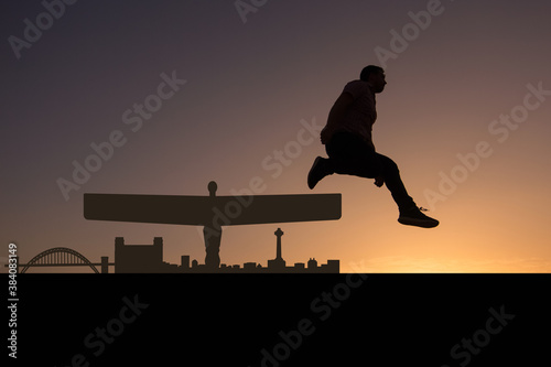 man next to silhouette skyline of Gateshead city photo