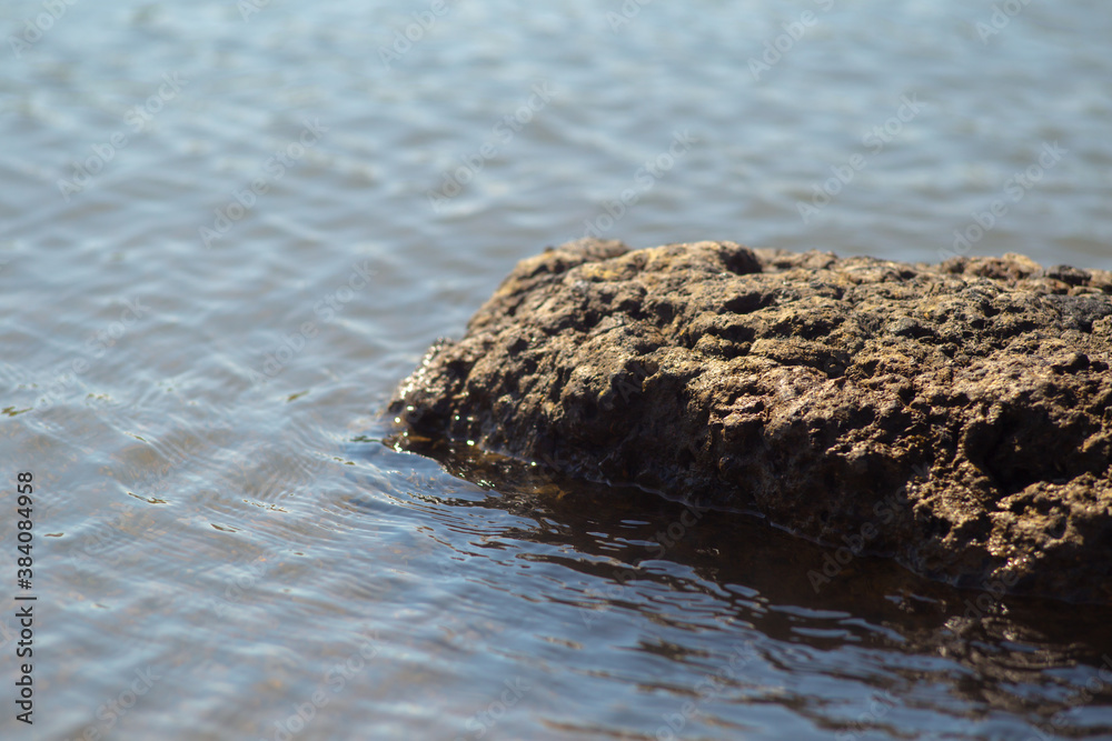 Rocky rock in the blue ocean water Rocky rock in the blue ocean water