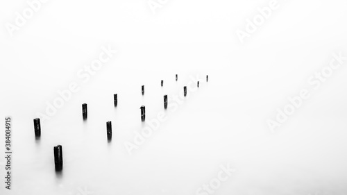 Minimalistic fine art photograph of an old pier in the sea