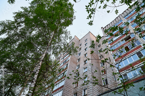 Big house and blue sky with clouds behind. Big block of flats in a summer day photo