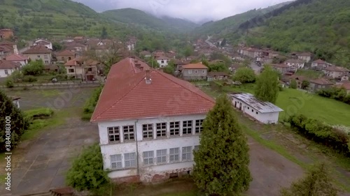 Wallpaper Mural Drone shot of a city and buildings among green trees area and  rainy clouds over the mountains in distance and view of architecture landscape Torontodigital.ca
