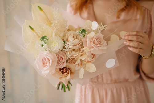 woman holding a bouquet of flowers french rose anthurium dahlias Lunaria ruscus dried flowers mattiola white peony rose photo