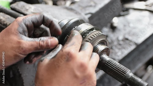 Car Mechanic or Auto Mechanic Cutting  Drive Shaft Rubber Boot Band in Zoom View