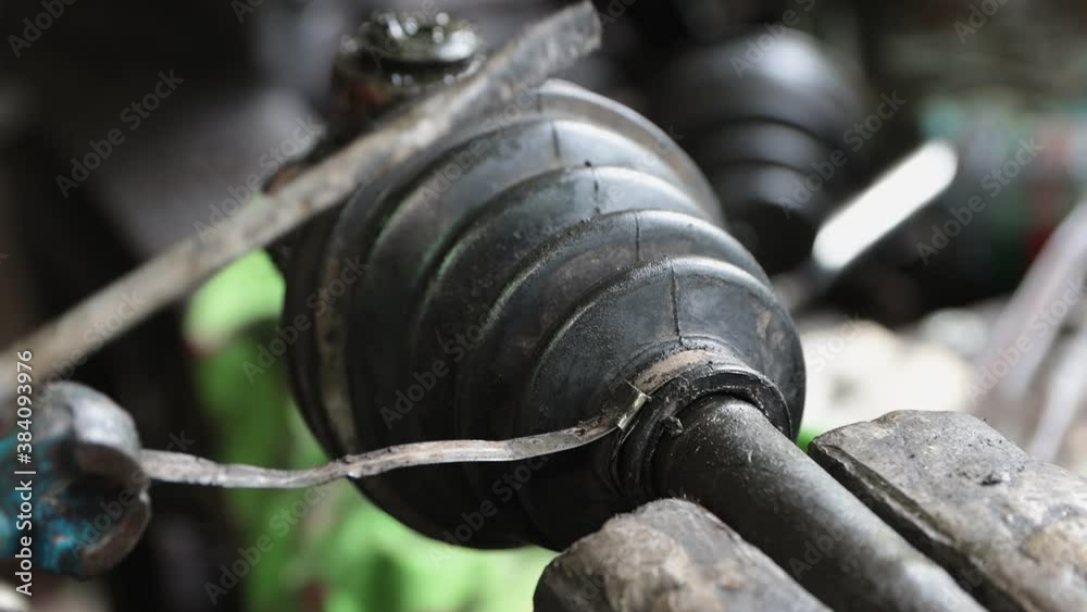 Car Mechanic or Auto Mechanic Assembly Drive Shaft Rubber Boot by Pliers in Zoom View Car Mechanic or Auto Mechanic Assembly Drive Shaft Rubber Boot by Pliers in Zoom View