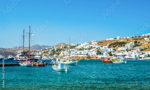 Ships on blue water with Mykonos island at background