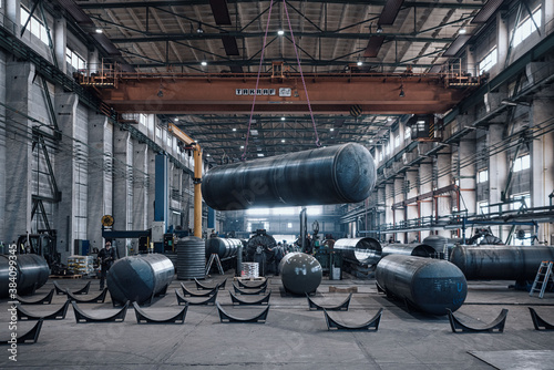Heavy industry construction plant  - Crane lifting heavy tanks during construction