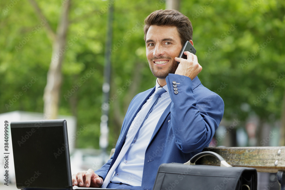 businessman handsome young sitting outside office with using laptop businessman handsome young sitting outside office with using laptop