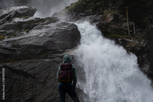 Young hiker stands in front of the Krimmler waterfalls