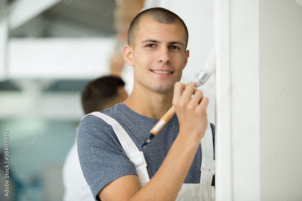 young commercial painter painting wall edge young commercial painter painting wall edge