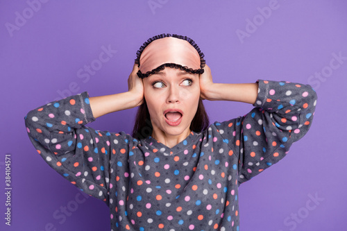 Photo of shocked crazy girl close cover hands cant sleep neighbors loud music noise wear dotted pajama eye mask isolated over purple color background © deagreez