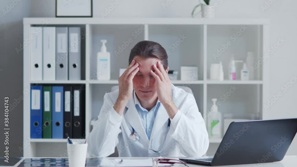 Tired and stressed medical doctor working in hospital office. Tired and stressed medical doctor working in hospital office.