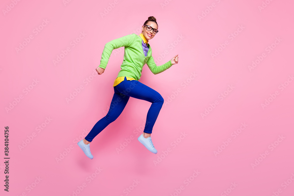 Full body profile side photo of cheerful lady jump run after high school season sales discounts wear green shirt blue pants trousers isolated over pastel color background